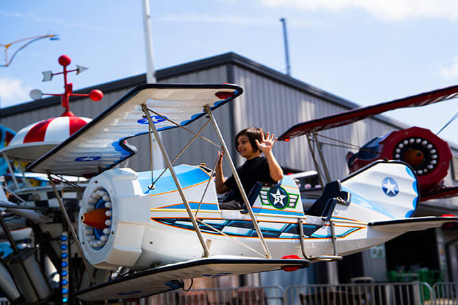 Child riding the Airplanes kiddie ride at Casino Pier