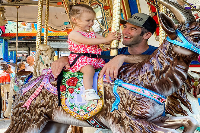 Child and dad riding the Carousel