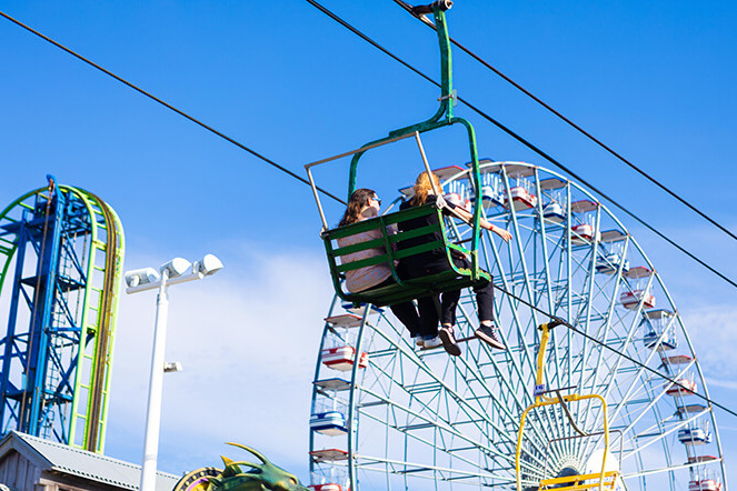 Riders on the Sky Ride beside the Ferris wheel