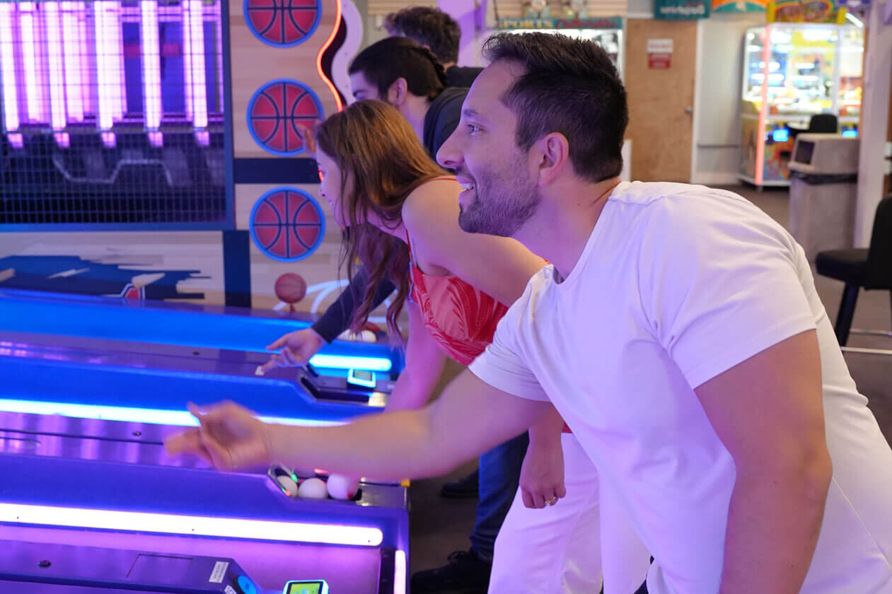 Family playing skee-ball at the Seaside Heights arcade