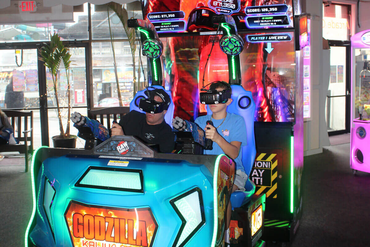 Kids inside the Godzilla arcade game
