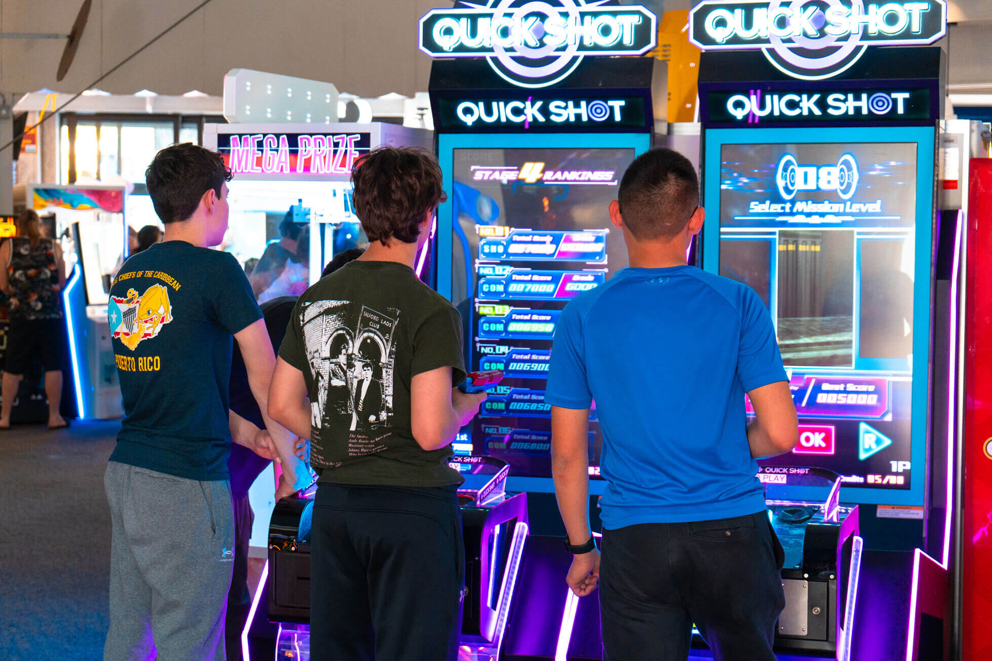 Teens playing Quick Shot arcade basketball