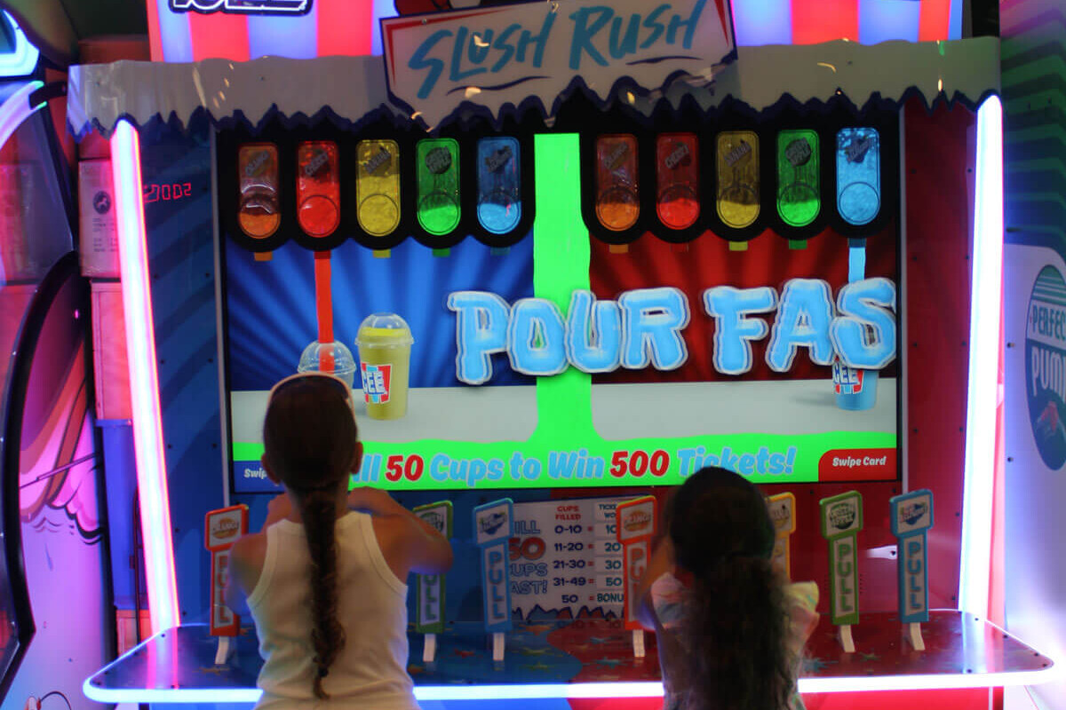 Kids playing a colorful ticket redemption game