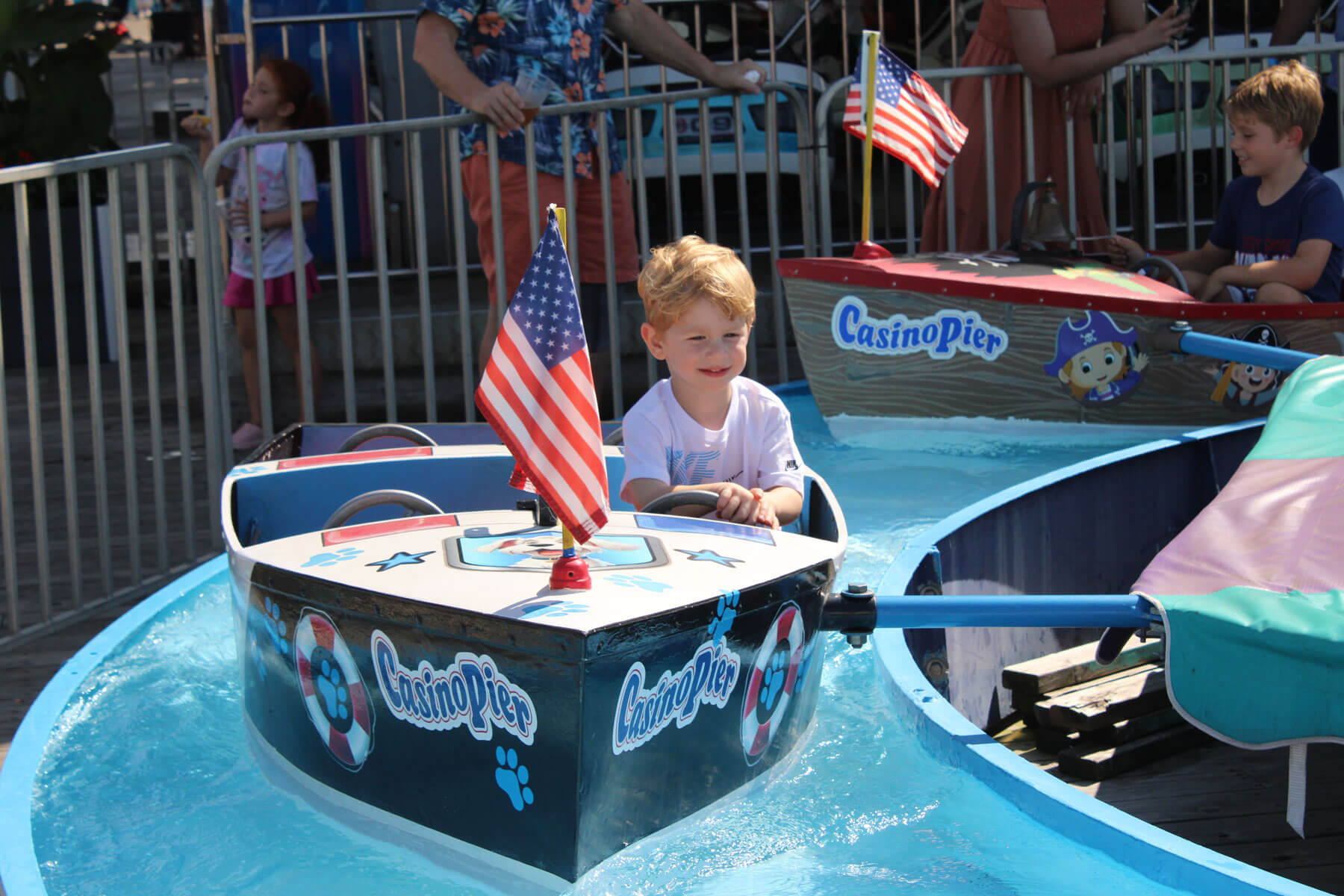 Boy riding the Boats kiddie ride