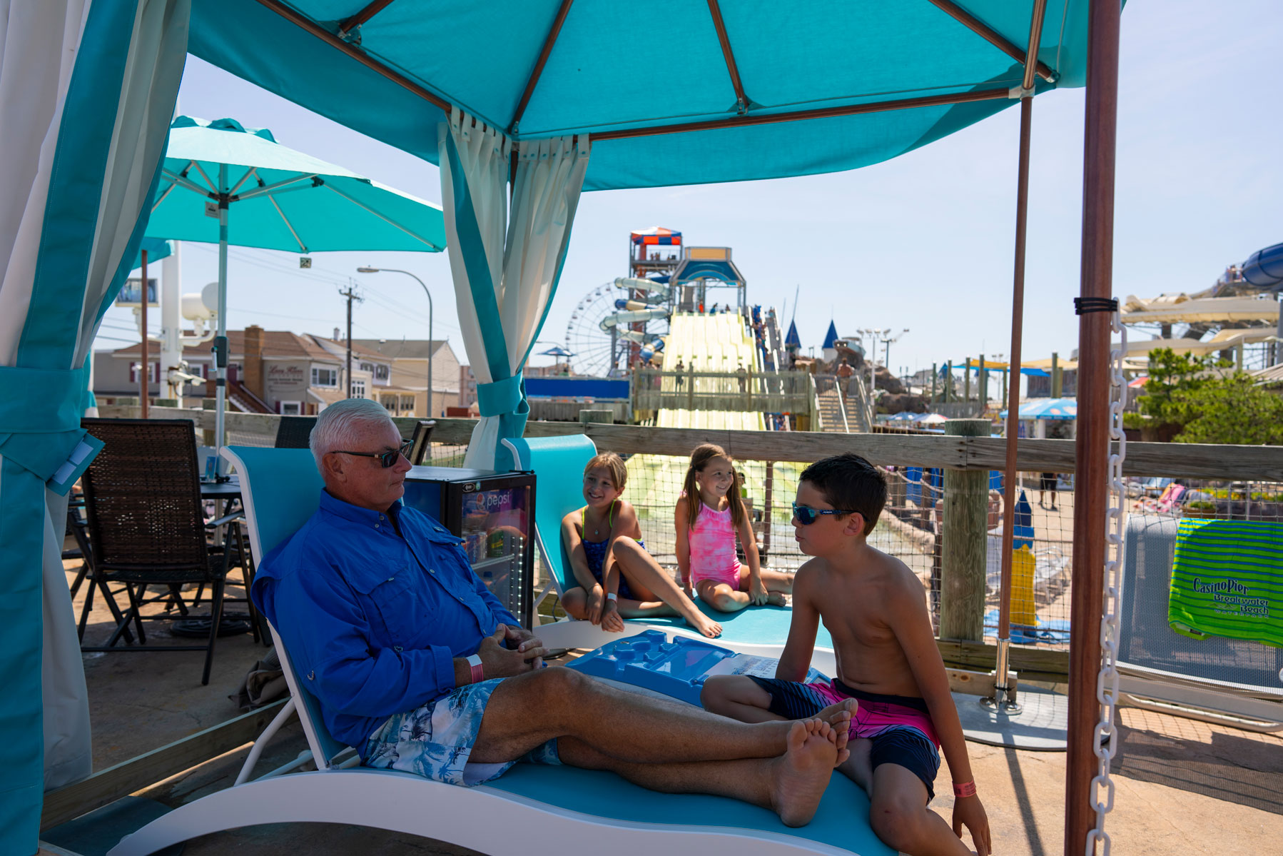 Family relaxing in a shaded Breakwater Beach cabana