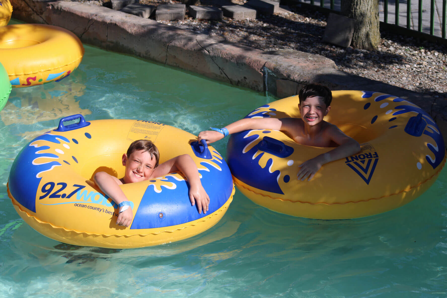 Kids floating on tubes during a Ride & Slide party