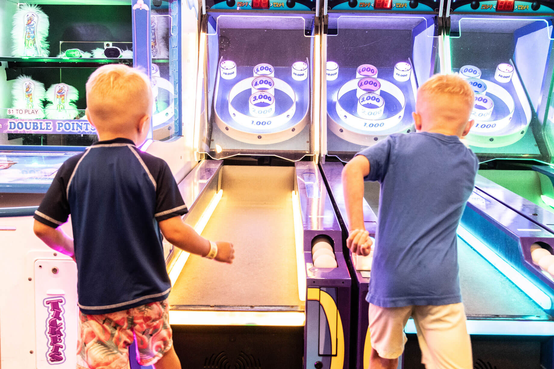 Kids playing skee-ball in the Casino Pier arcade
