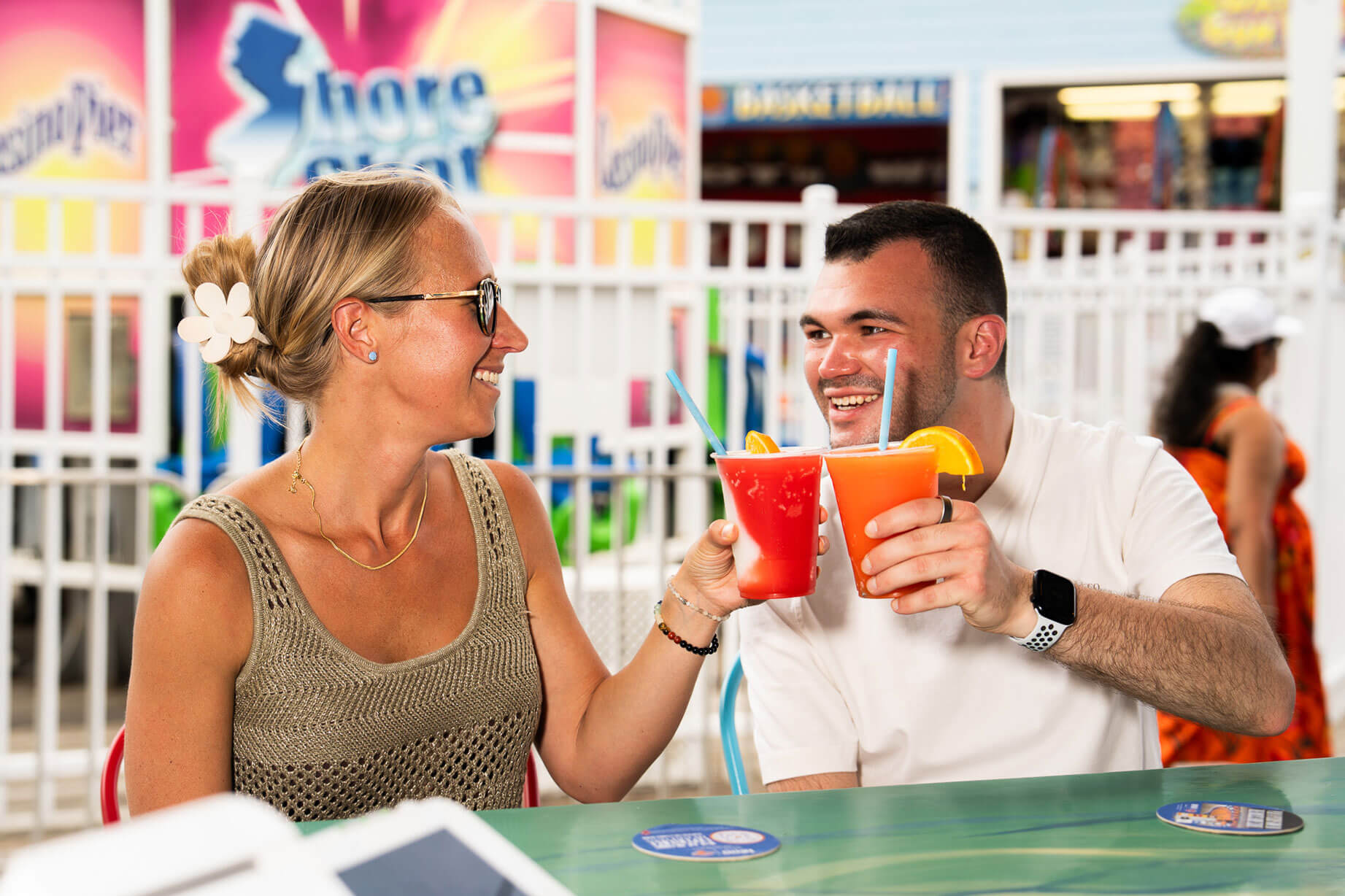 Couple toasting drinks on the boardwalk