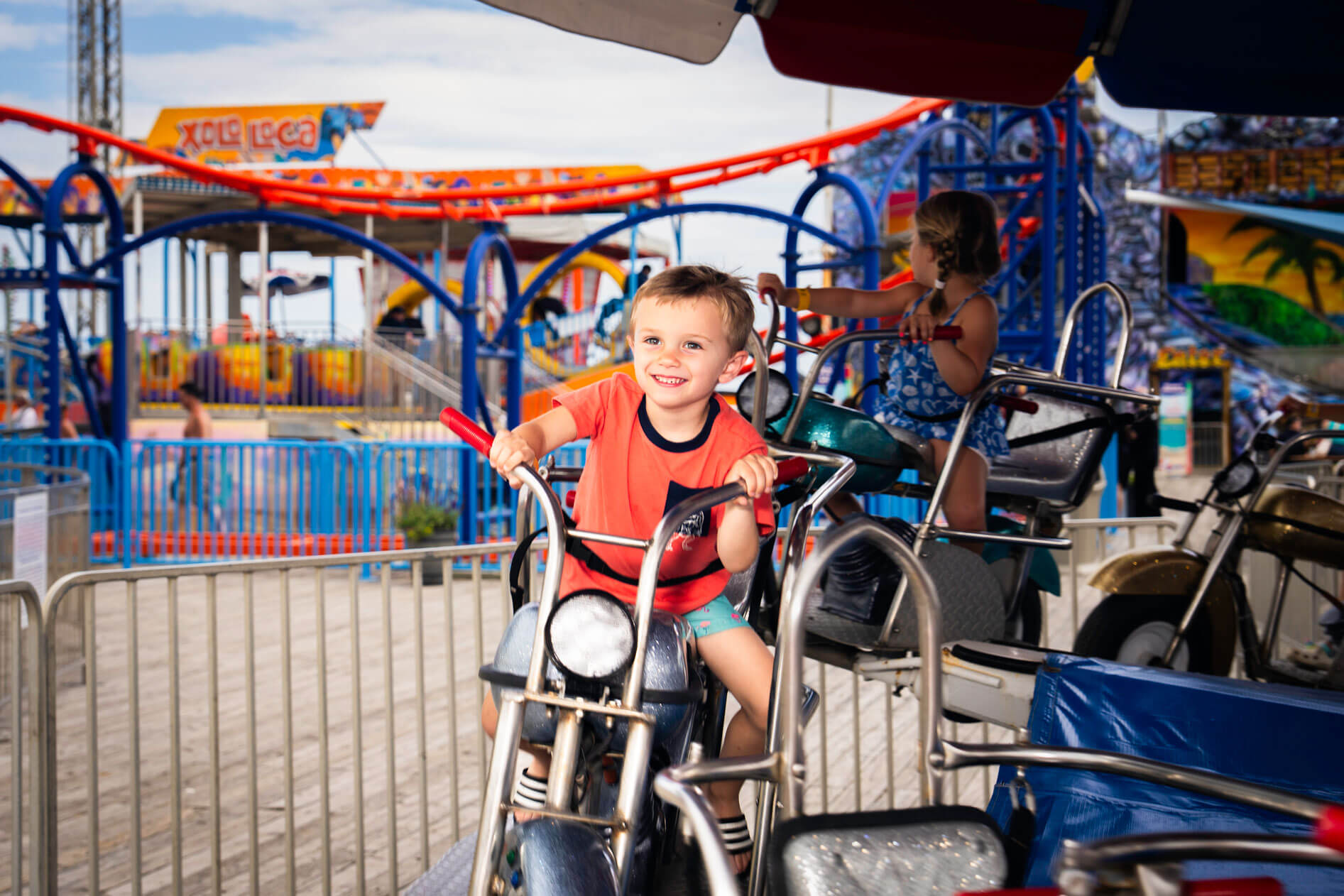 Boy riding the Motorcycles kiddie ride
