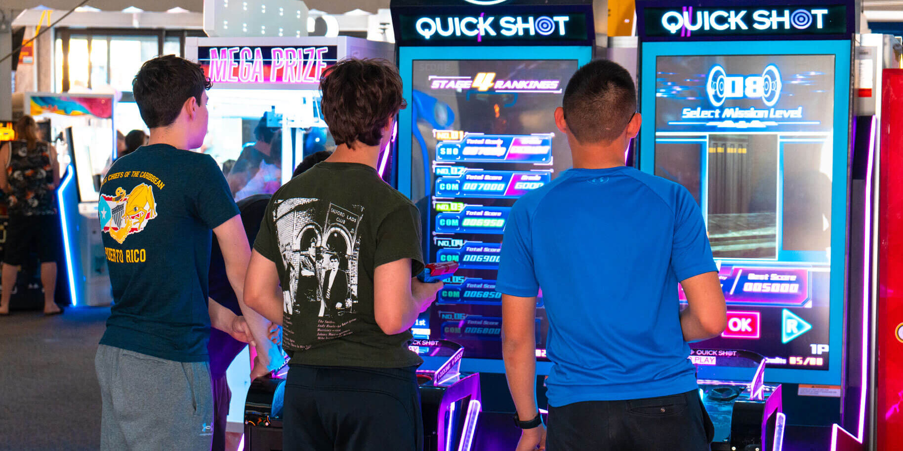 Teens playing Quick Shot basketball in the Casino Arcade