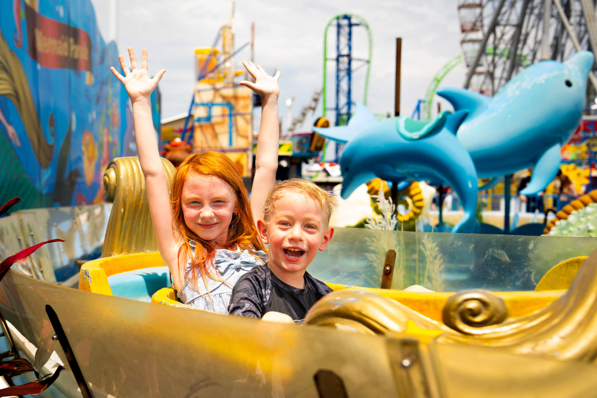 Kids cheering on a ride during a Casino Pier ride party