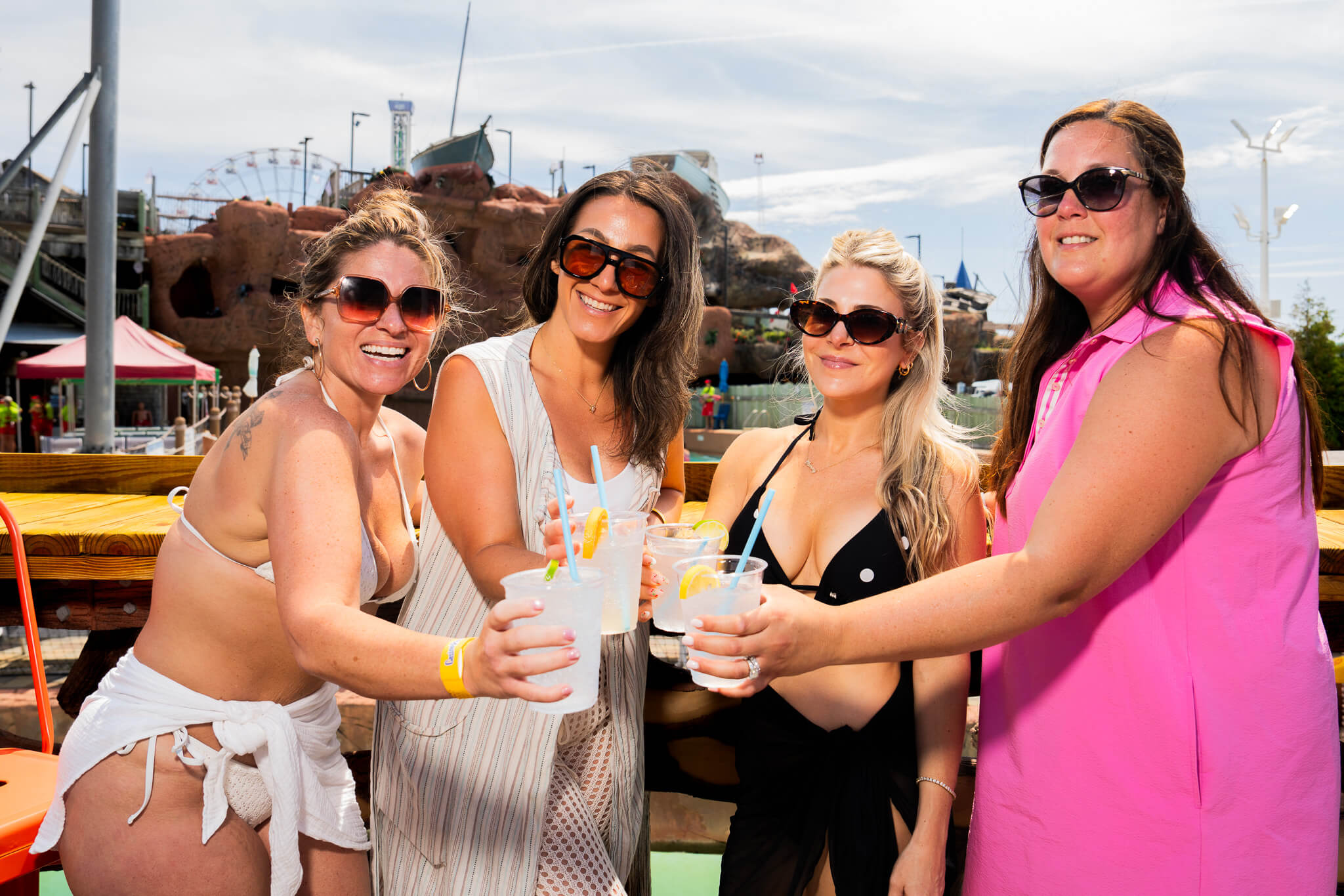 Friends toasting drinks at a Breakwater Beach special event