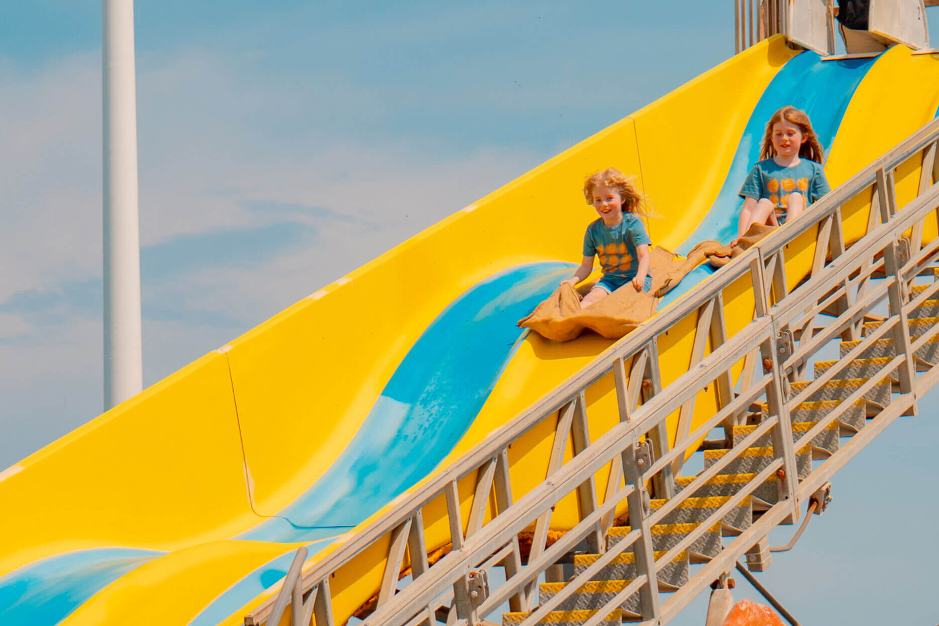 Kids racing down the Super Slide