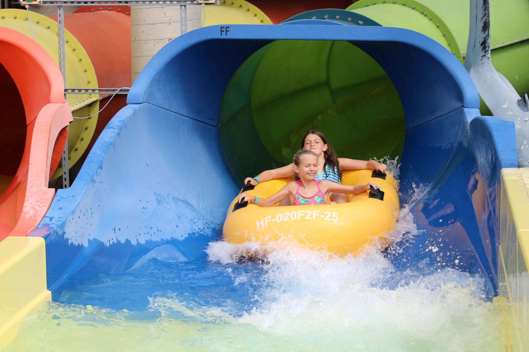 Riders exiting the Liberty Launch bowl tube slide